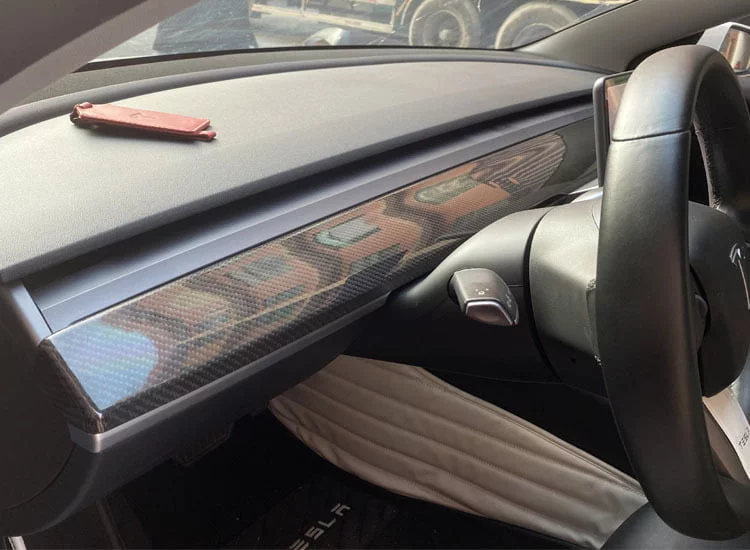 Tesla Model 3/Y dashboard featuring a carbon fiber patterned wrap for a sleek interior upgrade