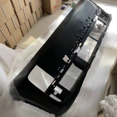 Black front bumper for Lixiang electric vehicle, with mounting points visible, on a warehouse floor